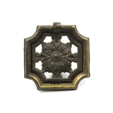 this is an antique vintage ring pull with a floral design in the center