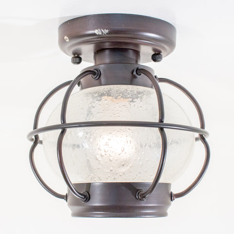 this is a ceiling fixture that looks like a lantern and it is lit up