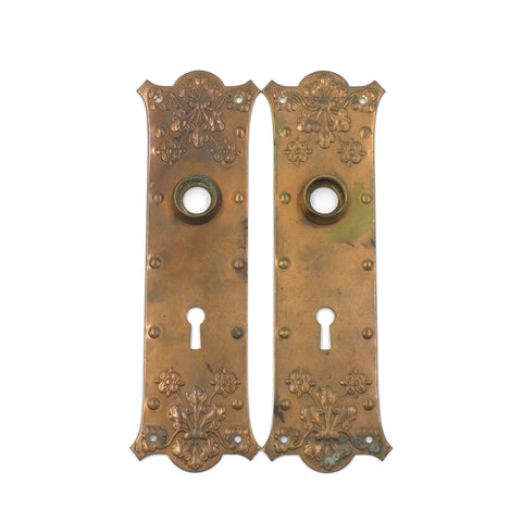 this is a pair of vintage floral copper escutcheons