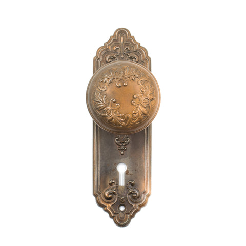this is an antique bronze coated corbin door knob set with escutcheons