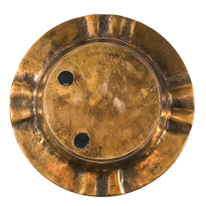 The bottom of the ash tray, which has two small plastic feet filed mostly flat, and a circle where there was once a third foot. There is minor pitting and some scratches.