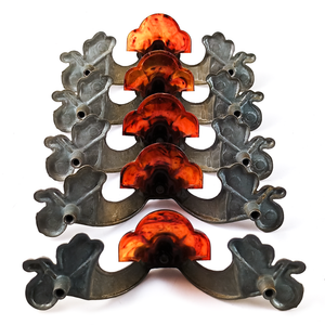 The backs of the five pictured handles, which are a matte grey and have marks indicating these are likely cast metal
