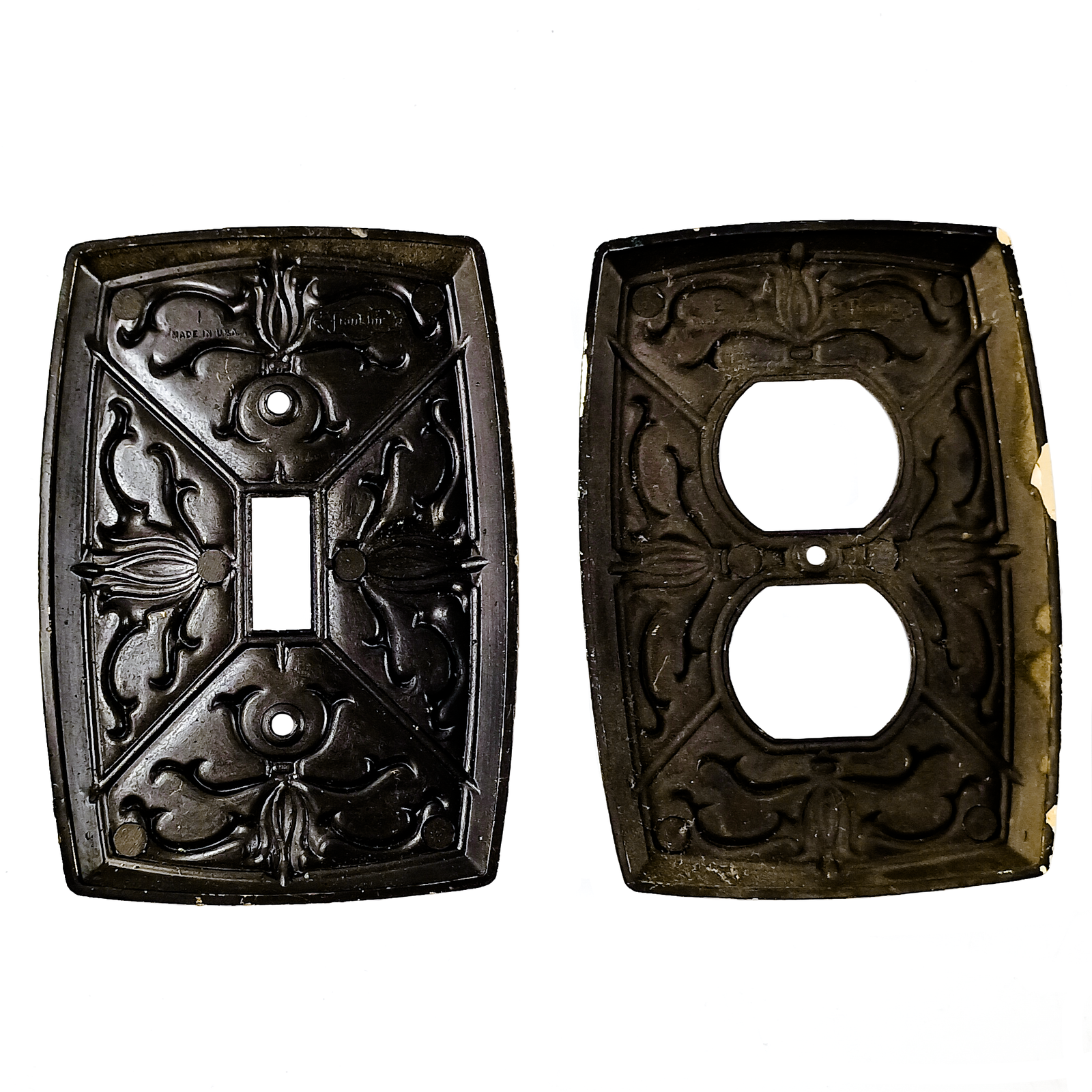 Vintage brass electrical plates with raised scrollwork designs and some patina