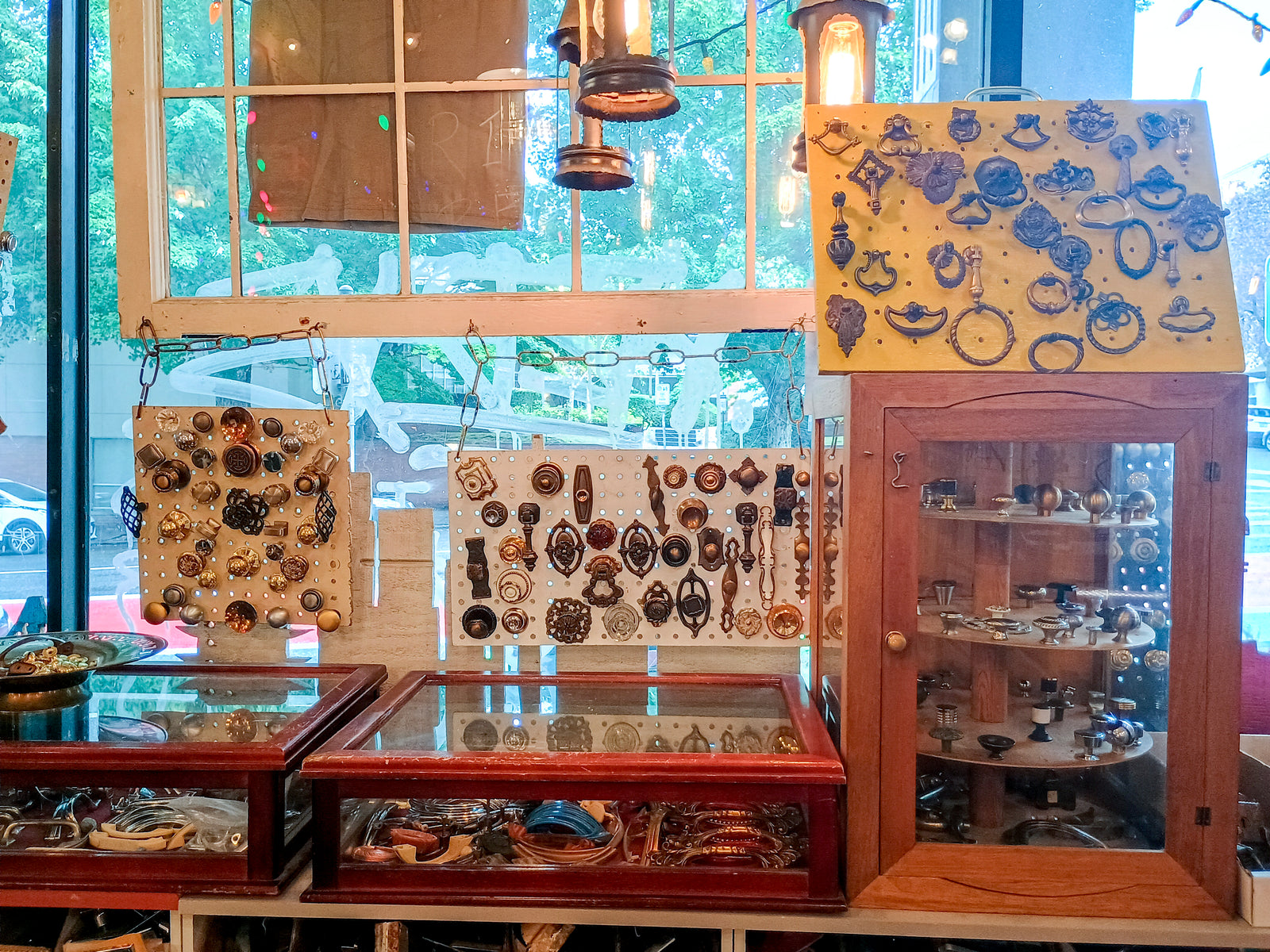 Several very fancy styles of drawer handle, in cases or screwed onto display boards