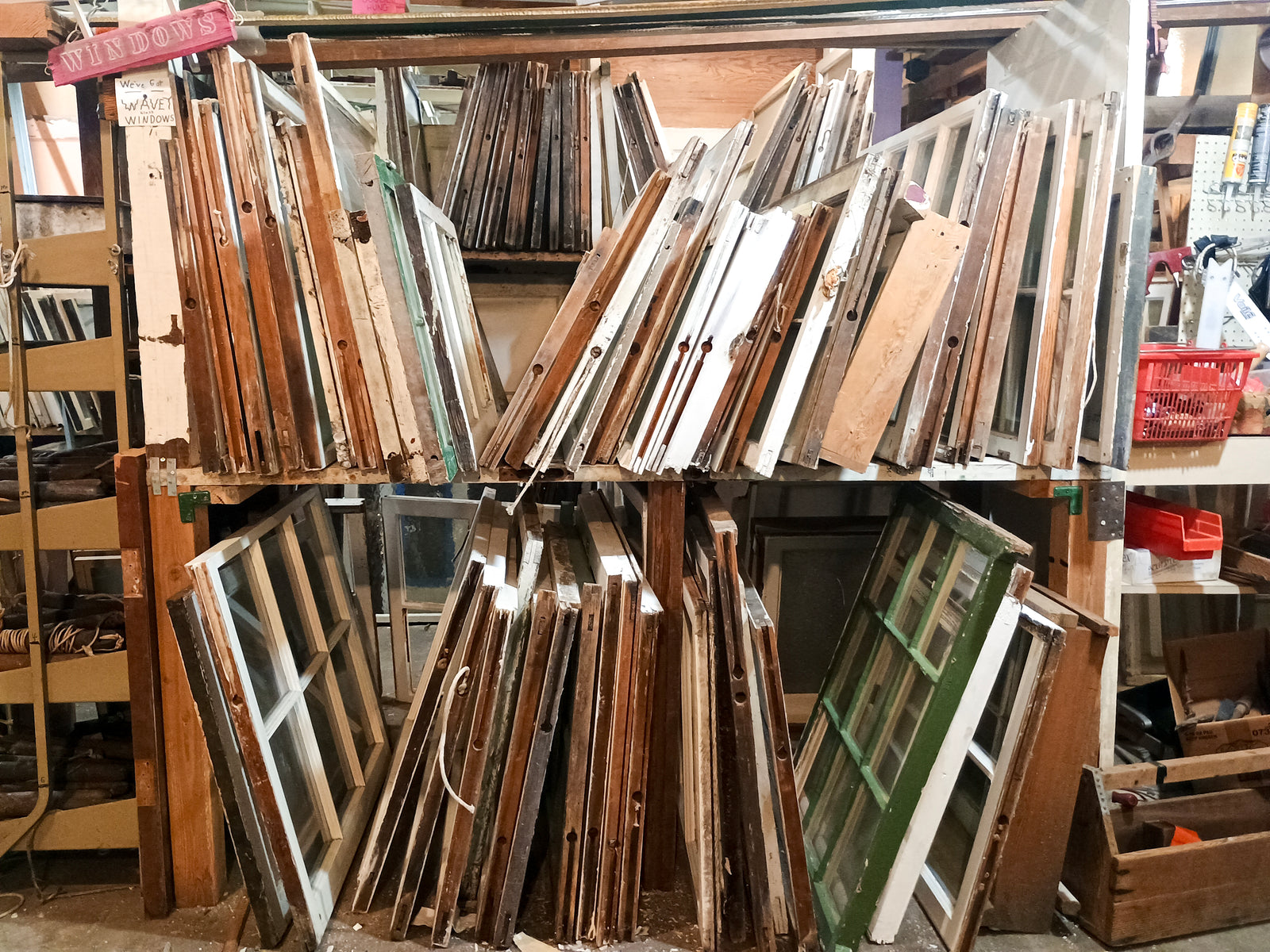 Two shelves of many medium-sized windows, with a sign reading "WINDOWS" and another reading "We've got WAVEY windows," with the word "WAVEY" drawn in wiggly letters