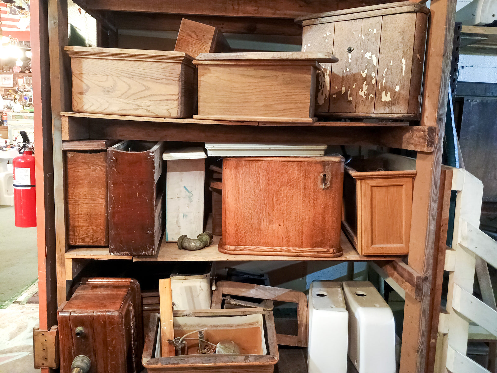Three shelves of wooden toilet tanks