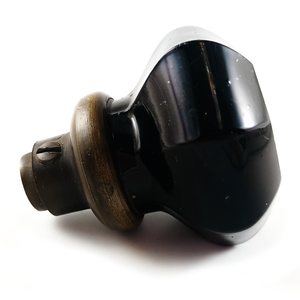 A side view of the knob with the loose collar, showing that the base has a darker patina on it