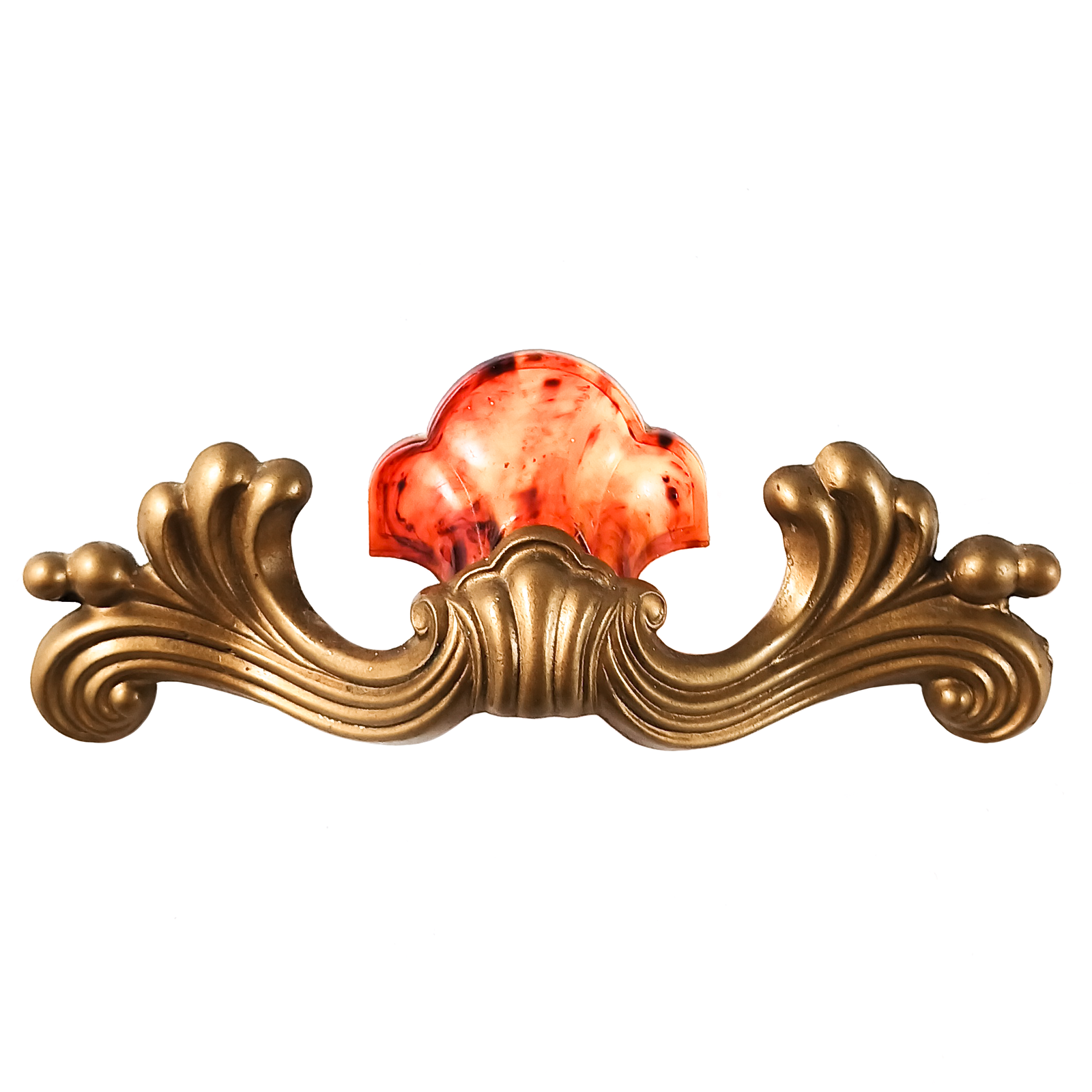 A single drawer handle, primarily gold-tone scrollwork with a shell shape made of marbled orange plastic on the top.