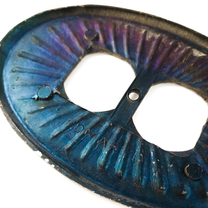 A close-up of the back of the outlet cover, showing the EDMAR stamp more clearly