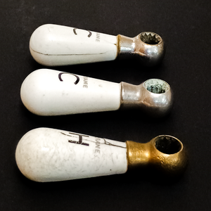 A side view of the three handles, showing a crack along the side of the moderately damaged cold handle