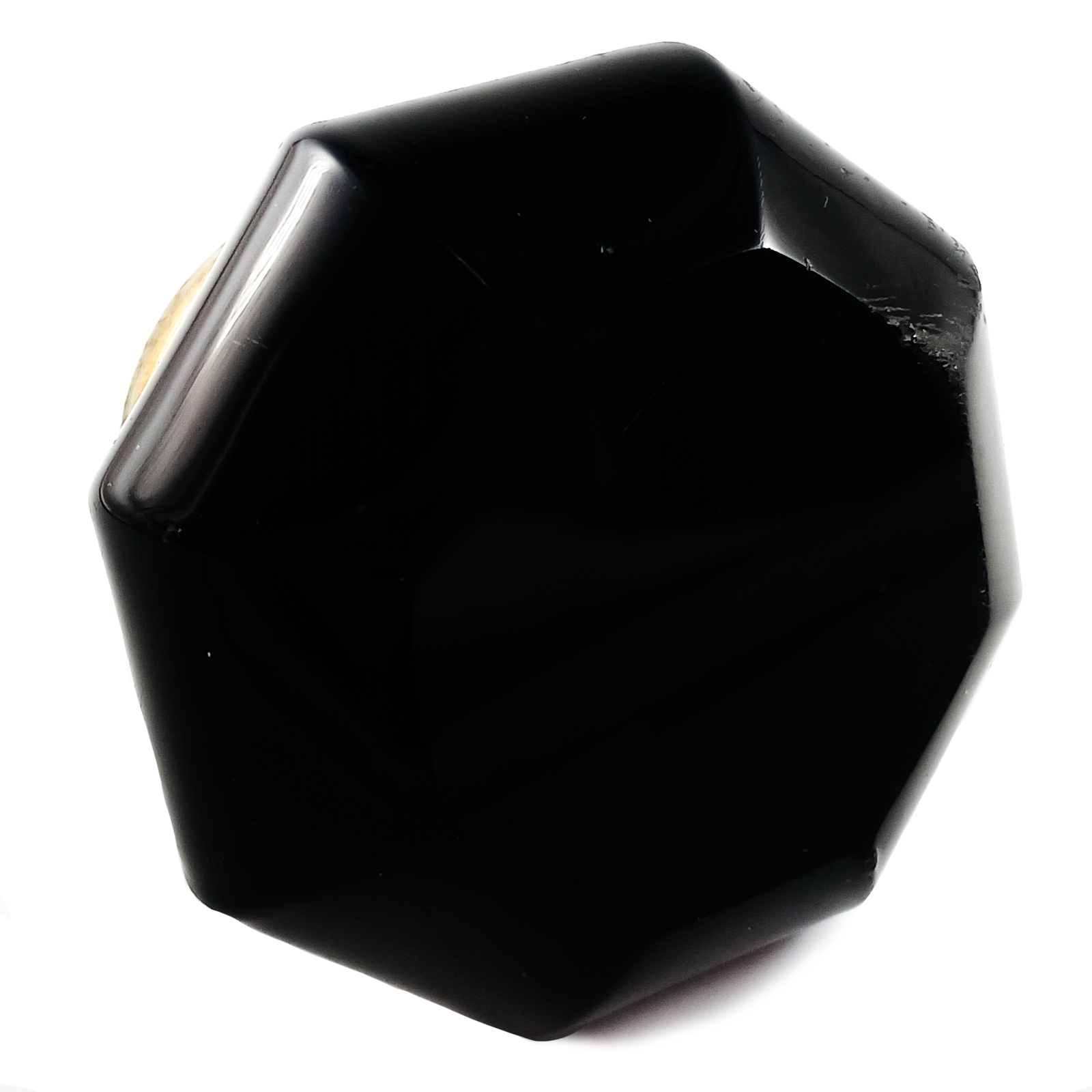 An angled shot of two black glass doorknobs with brass bases
