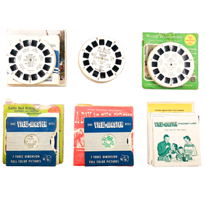A collection of View-Master reels and papers, sorted into six stacks
