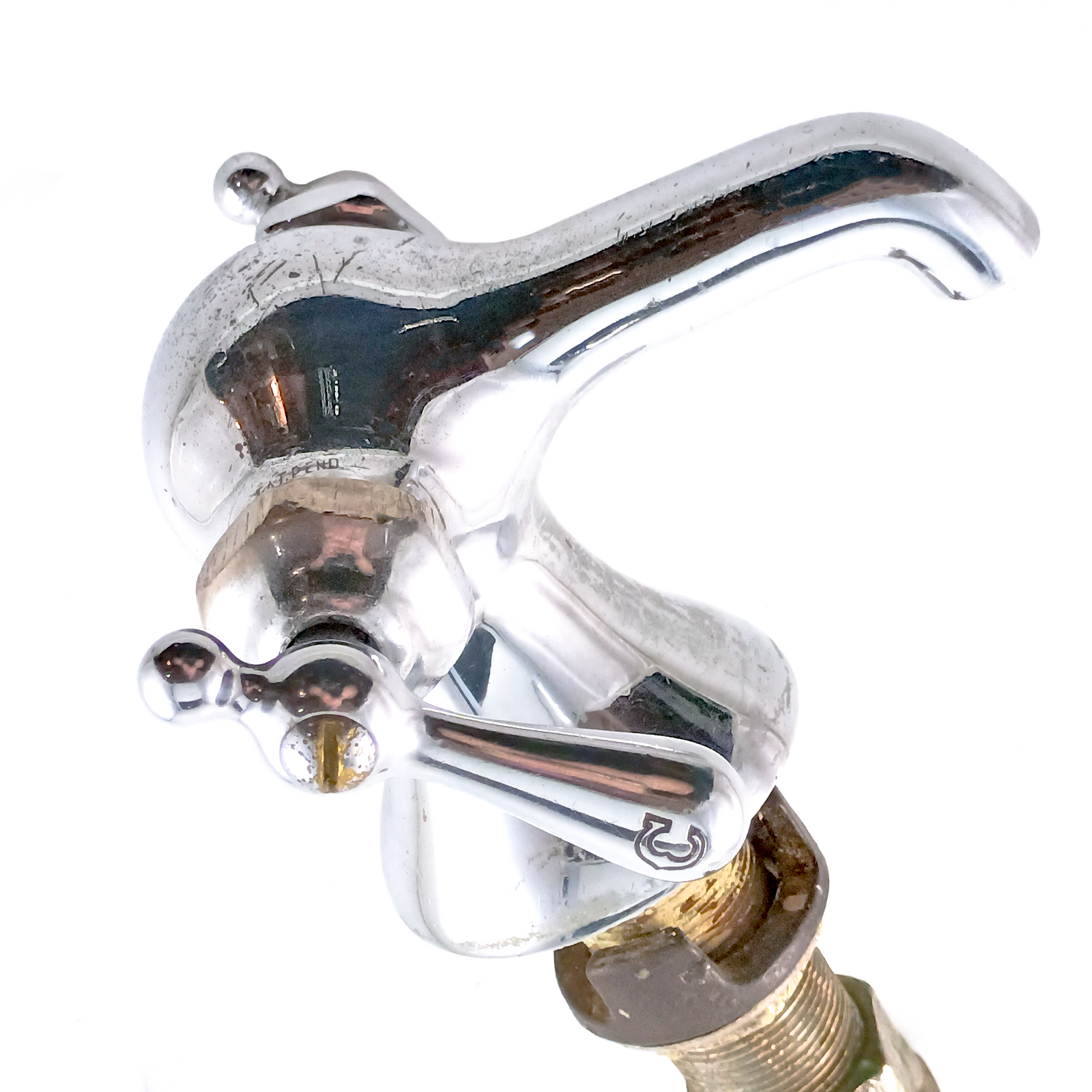 A vintage faucet with some surface scratches and a lever handle reading "C" in a fancy font