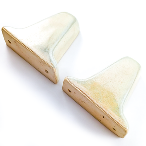 An angled view of the outer sides and the unglazed backs of each piece, showing the darker edges of the glaze