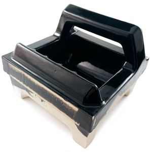 An angled view of the underside of a tile-in inset soap dish, showing a grab bar protruding from the top of the piece