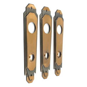 An angled view of three bronze Art Deco escutcheons