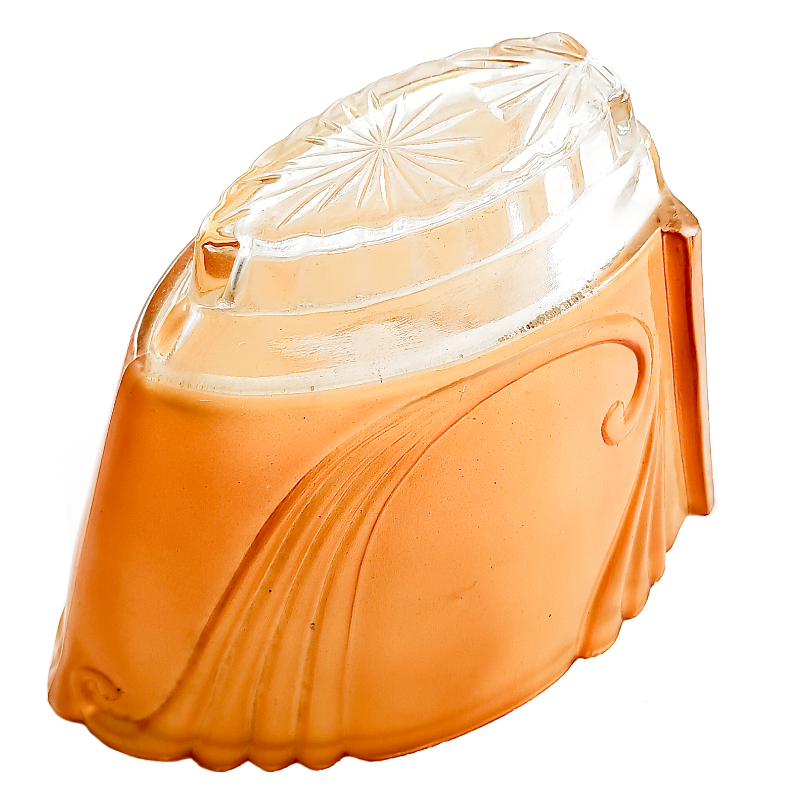 An orange glass slip shade with scrolling designs along the side, as well as a clear portion with a starburst design pressed into it