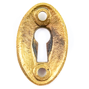 The back of a vintage brass oval keyhole escutcheon