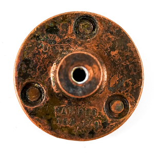 The back of a round copper cabinet knob, stamped "PAT DES. 192179"