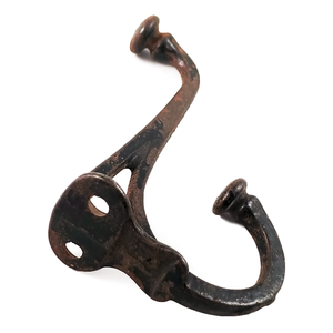 The back of a cast iron antique double coat hook, with two screw holes