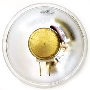 The back of a Westinghouse par lamp, which has a brass mounting for a plug in the middle of a convex silver surface