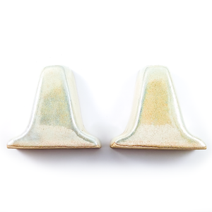 The outer sides of the holders, which are completely smooth and show the mottled glaze very well