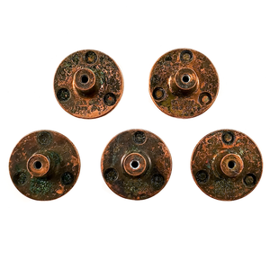 The backs of five round copper cabinet knobs arranged in two rows, each stamped "PAT DES 192179"