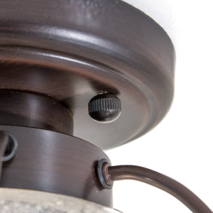 A close-up of the base of a ceiling-mounted lighting fixture
