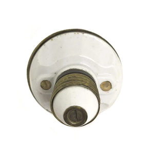 The porcelain and brass base of an antique two-socket Benjamin cluster