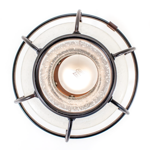 An industrial-style ceiling-mounted light fixture shaped like a lantern, with dark bronze metal and bubbly clear glass, photographed from below with a bulb for display