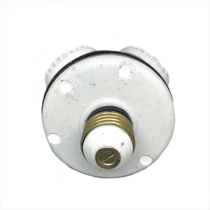 The back of a four-socket Benjamin fixture, made primarily of white ceramic with a brass and ceramic threaded base that screws into a light socket