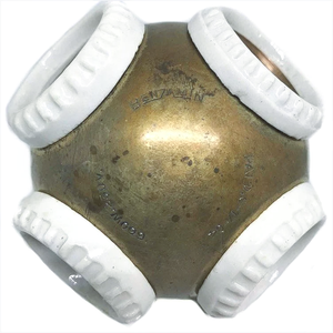 A closer view of the text on a brass four-socket fixture, reaind "BENJAMIN 660W 2660V PAT.D 6-17-04"