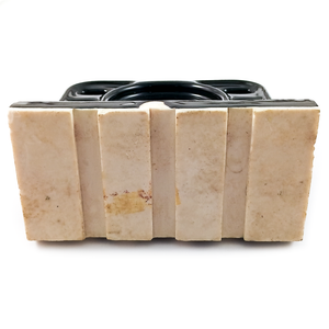 The back of a porcelain wall-mounted toothbrush holder. The toothbrush holder is glazed in black, but this portion is off-white porcelain, with four raised vertical rectangular areas and three indents between them.