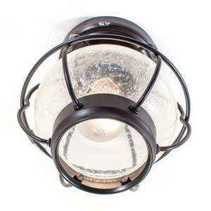An industrial-style ceiling-mounted light fixture shaped like a lantern, with dark bronze metal and bubbly clear glass
