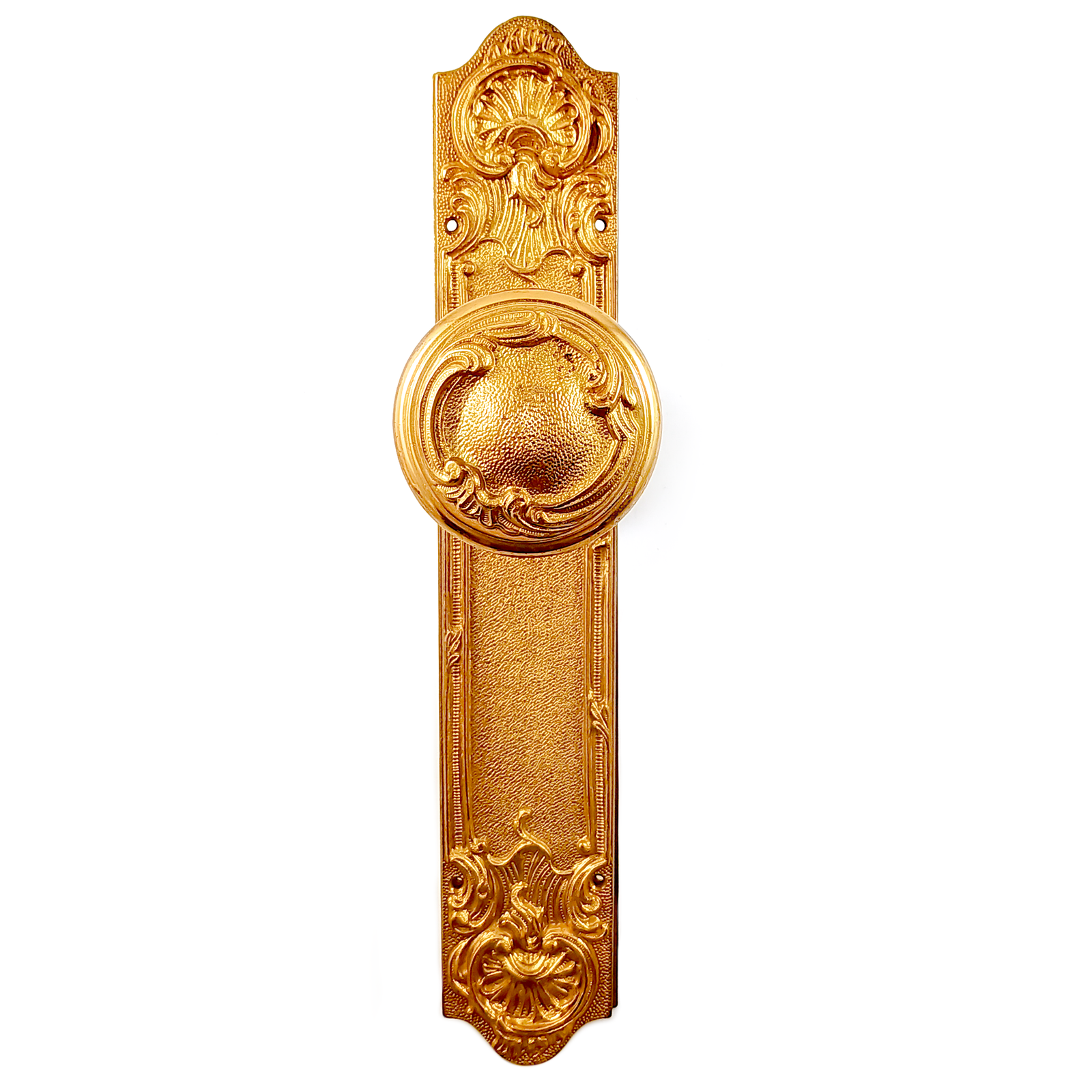 A vintage brass doorknob and escutcheon set, decorated in an Art Nouveau revivalist style with ornate scrolling details
