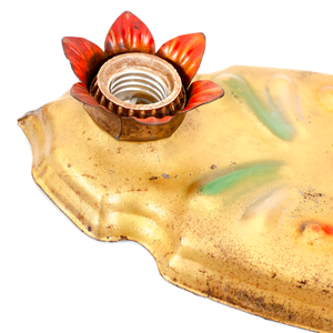 A close-up of a light socket in a vintage gold-tone fixture. The socket is surrounded by metal flower petals which have been painted red.