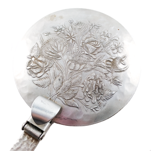 An up-close look at the floral design on the lid. This closer look also shows some of the surface wear/damage.