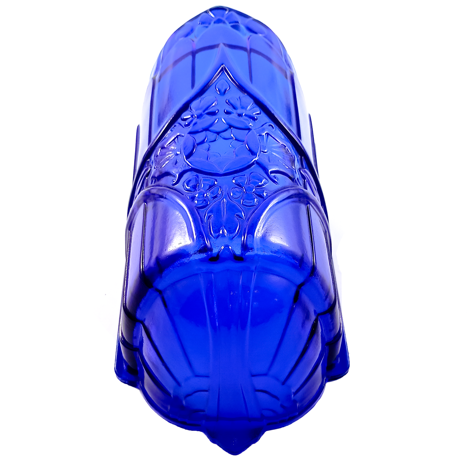 A cobalt blue glass slip shade with a rounded base and a pressed design in the middle mixing geometric and floral elements