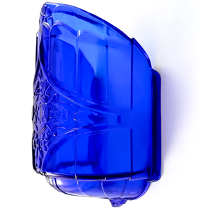 A side view of a cobalt blue glass slip shade with a rounded base and pressed designs incorporating Art Nouveau and Art Deco elements