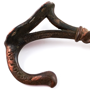 The stamp on a copper-flashed black iron coat hook, reading "No 700567"