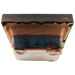 The top and back of a wall-mounted porcelain soap dish