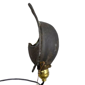 A side view of an antique iron wall sconce, showing that the sconce itself is curved and would require an inset, curved space to mount it