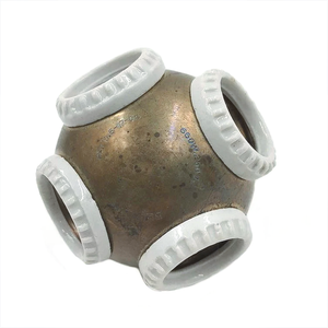 A brass ball with four white ceramic rings on it, each surrounding a light socket