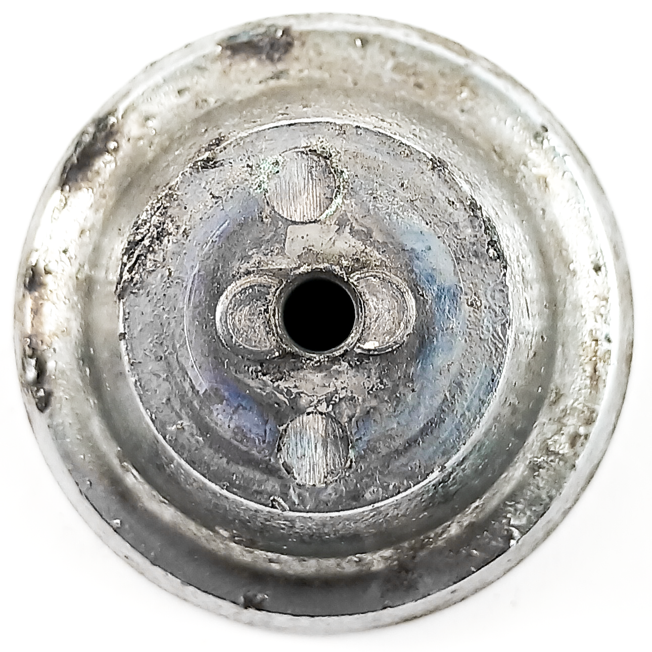 A round turquoise and chrome knob depicting the Frigidaire logo, along with a large five-pointed crown