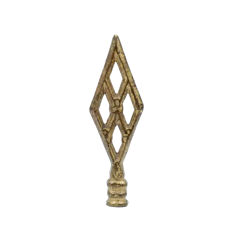 A vintage brass finial in the shape of four diamonds, forming a larger overall diamond shape