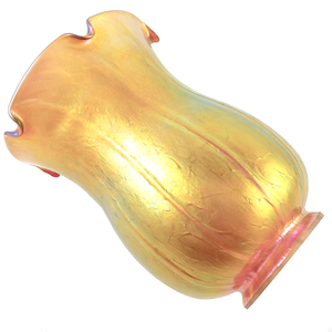 An iridescent golden tulip-shaped lamp shade with a textured surface and areas of green, purple, and pink iridescence