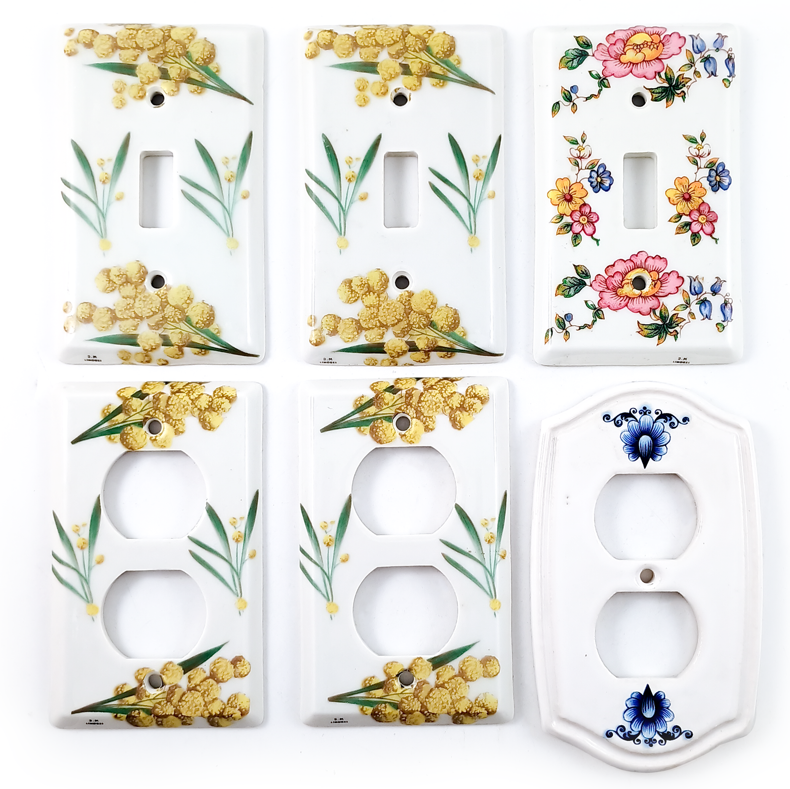 Six porcelain light switch plates and double outlet covers, three of each. They are decorated in a variety of floral motifs.