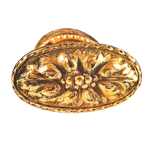 A close-up of the other knob, which has the same design but less patina.