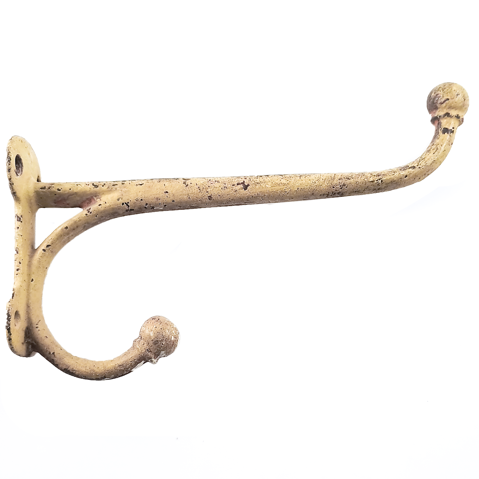A very large cast iron coat hook facing to the right, covered in a coating of off-white paint that has worn and flaked off in spots
