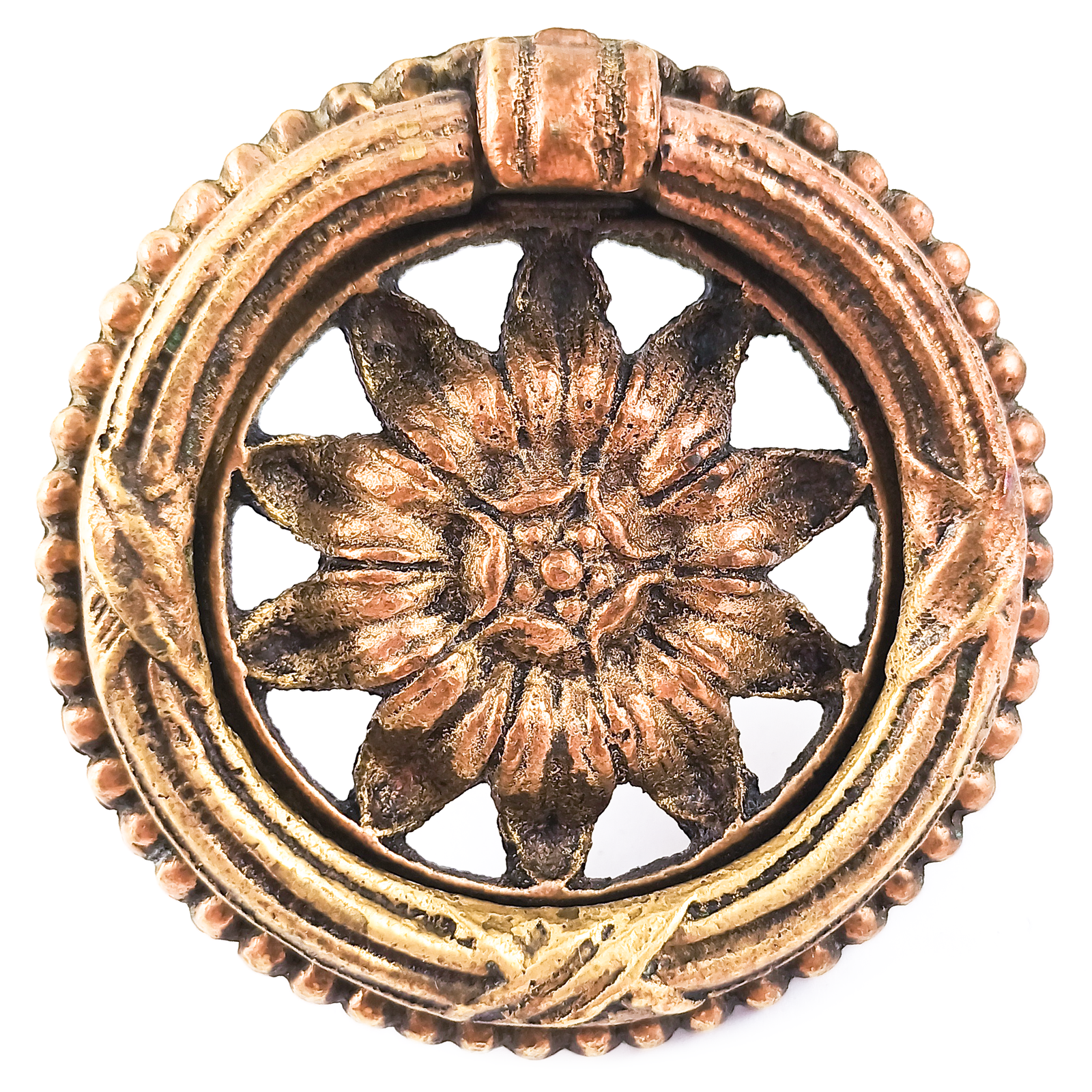 An ornately-decorated vintage brass ring pull with a sunflower design in the middle.